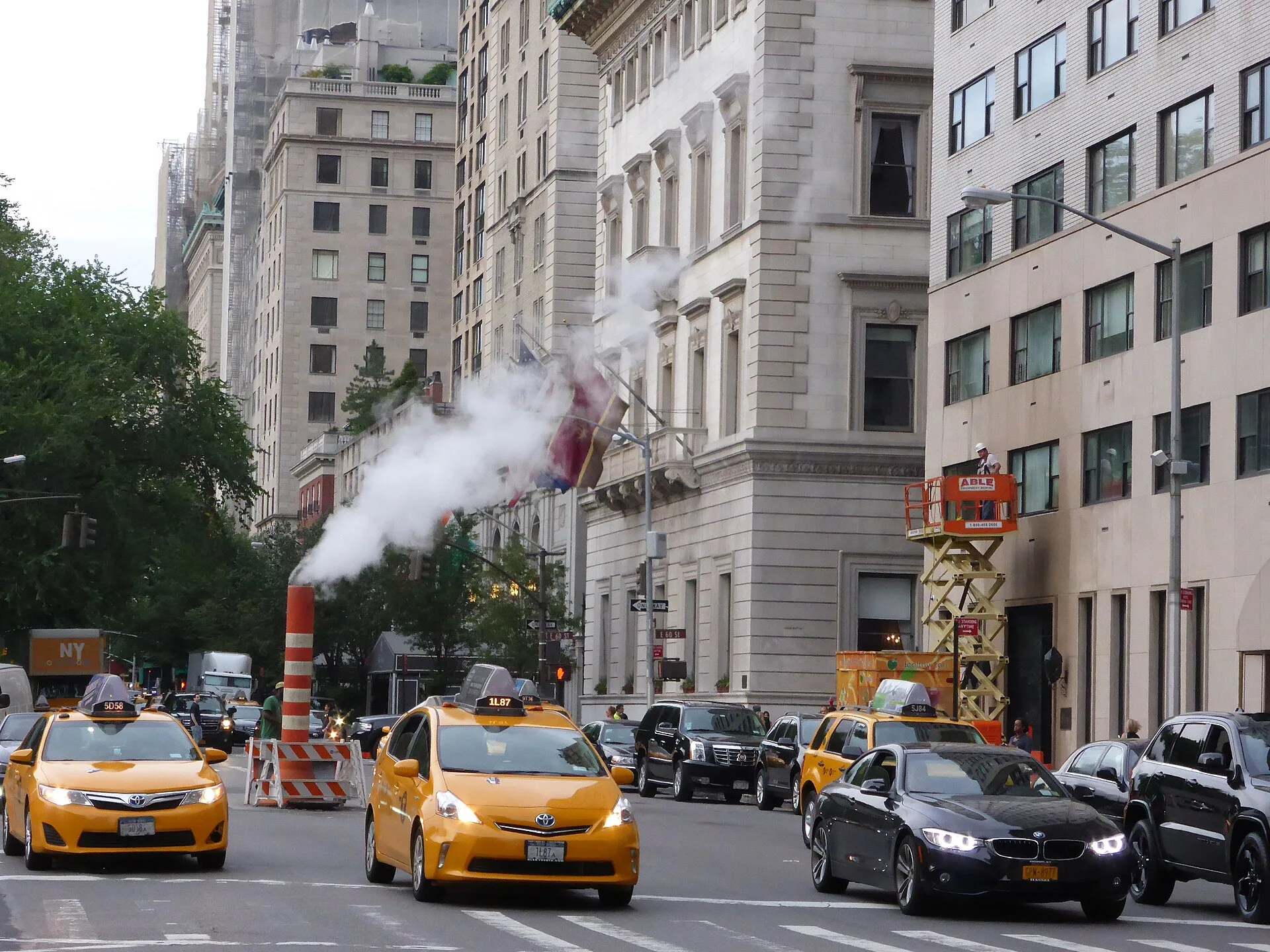 Photograph of 5th Avenue in Manhattan (New York City) near E60th Street, looking in north-east direction. In the front of the picture one can see two yellow taxis and a window washer on a lifting ramp. Steam vapor being vented through a orange and white stack (see New York City steam system ). Window Cleaning Subcontractor Agreement vs Employee: Which Should You Use?