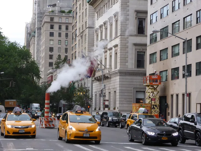 Photograph of 5th Avenue in Manhattan (New York City) near E60th Street, looking in north-east direction. In the front of the picture one can see two yellow taxis and a window washer on a lifting ramp. Steam vapor being vented through a orange and white stack (see New York City steam system ). Window Cleaning Subcontractor Agreement vs Employee: Which Should You Use?